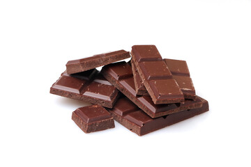 Pieces of dark chocolate on a white background.