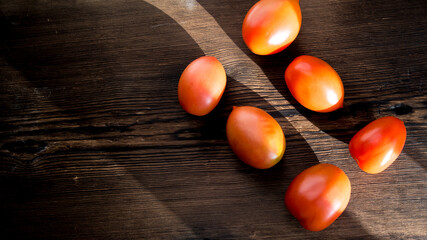 Red tomatoes,tomatoes on a dark old wooden table,close-up