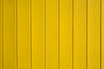 Wooden boards painted with yellow paint. Background Texture