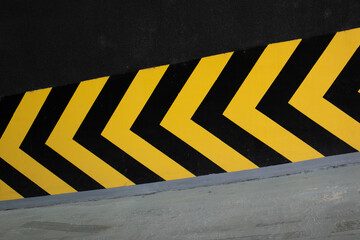 Yellow and black arrows pointing toward basement parking garage