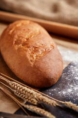 Assorted different types of bread, gluten-free bread, close-up on a dark background. French baguette with sesame seeds. Place for text