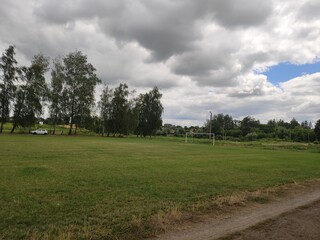 Fototapeta premium large soccer field with green grass in summer