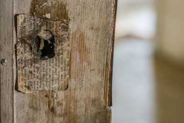 note on a wooden door frame in a castle