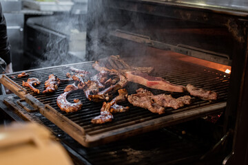 Pieces of meat on a restaurant grill