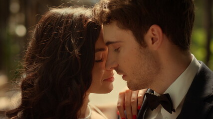 Romantic couple posing in park. Closeup fancy man and woman hugging outdoors