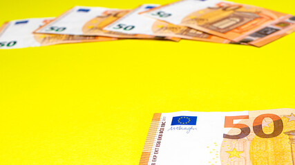 Fragment of the 50 fifty euro banknote on a yellow background. Close up currency money. Place for text. Cop