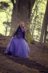 Naklejka premium woman in forest with violet dress