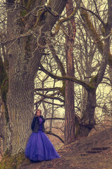 woman in forest with violet dress