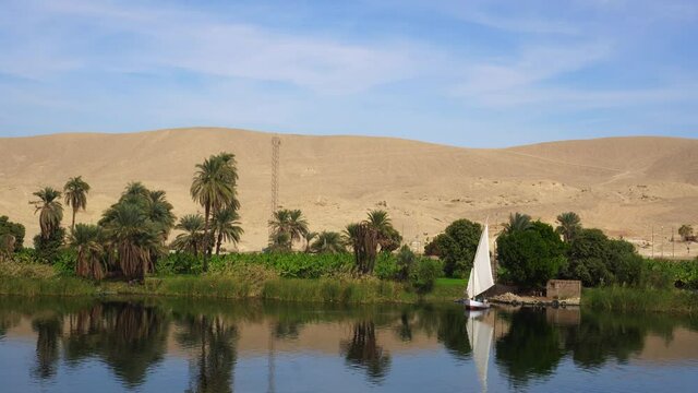 Nile river side view felluca boat and telephone signal tower in Egypt