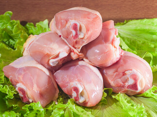 Raw chicken legs on salad
