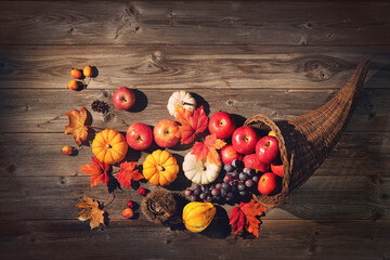 Thanksgiving cornucopia on a rustic wooden background
