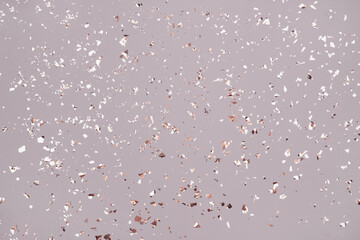 Festive grey background with holographic flying silver sparkles for your project. Holiday backdrop with copyspace. Birthday party, Christmas or New Year celebration concept