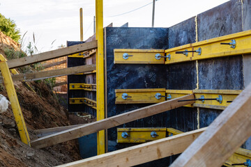 The construction of a retaining wall or counterfort, formwork, reinforced, preparation to pour concrete, construction site. Improvement of the territory. Preventive measures against landslide