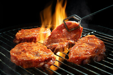 Marinated pork steaks on barbecue grill