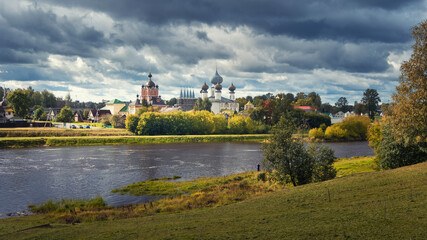 Fototapeta premium Panorama of the river and ancient Orthodox Tikhvin Bogorodichny Uspensky Male Monastery