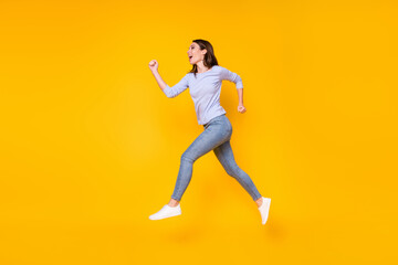 Fototapeta na wymiar Full length body size profile side view of her she nice attractive purposeful cheerful cheery girl jumping running discount spring season isolated bright vivid shine vibrant yellow color background