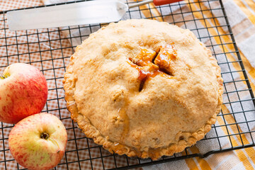 Autumn classic American fair apple pie with crust, on the kitchen table, autumn classic desserts 