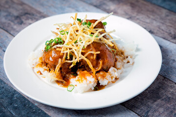 Fresh beef meatballs served with a sauce over a bed of rice