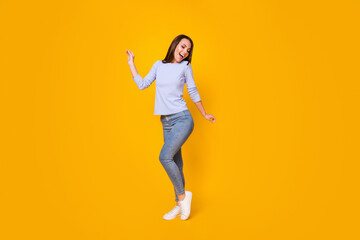 Full length body size view of her she attractive pretty lovely cheerful cheery girl having fun dancing good mood weekend pastime isolated bright vivid shine vibrant yellow color background