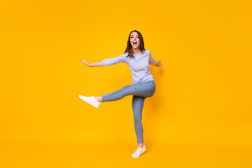 Fototapeta na wymiar Full length body size view of her she attractive pretty funky ecstatic slender cheerful cheery girl jumping having fun good mood dancing isolated bright vivid shine vibrant yellow color background