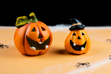  Two orange pumpkins on black background.