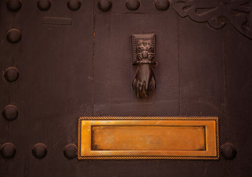 Old wooden front door with hand  knocker and letter box. Morocco, Marrakesh.
