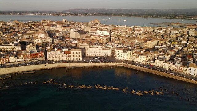 Cityscape and seaview from the height at sunrise in Ortygia (Ortigia) island in province of Siracusa (Syracuse) in Sicily
