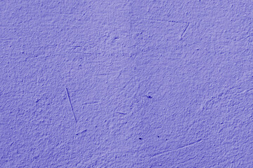 Purple wall, texture, background. Plastered building wall, painted with violet water-based paint. Decorated surface with embossed pattern. Elements of the exterior and interior