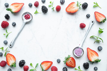 Frame made of fresh strawberry on marble background. Creative food concept. Top view, copy space.