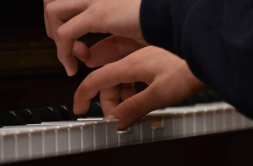 hands of a person playing piano