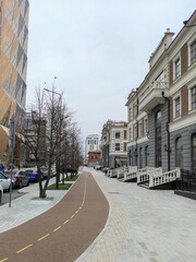 Obraz premium The bicycle path in downtown Yekaterinburg, Russia. Painted lane dividers for better flow, and rider control. Detail of the sidewalk and bike path of the city.
