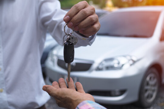 Sales agencies are selling cars and giving keys to new owners. sell car or rental car