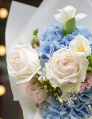 Colorful flowers assorted bouquet in paper. Holiday celebration concept. Bouquet of beautiful flowers in hands. Work of florist.