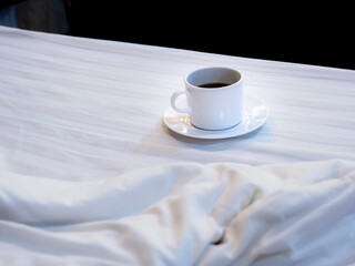 White Coffee Mug Rests on The White Mattress