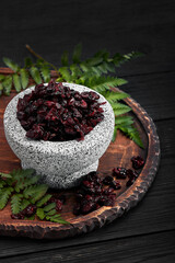Dried cherry in a bowl over gray background. Top view.