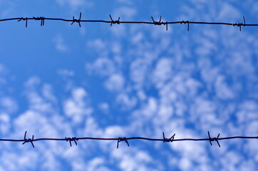 barbed wire against blue sky background