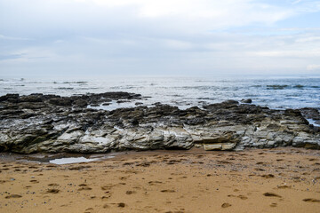Fototapeta na wymiar A rocky sandy beach off the coast of France.