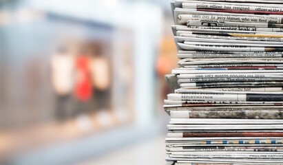 Pile of fresh newspapers on a blur background