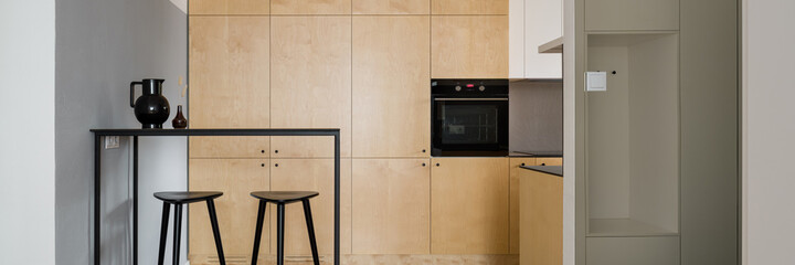 Fototapeta premium Kitchen with plywood cupboards, panorama