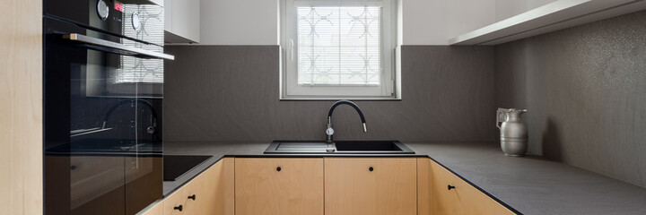 Elegant kitchen with small window, panorama