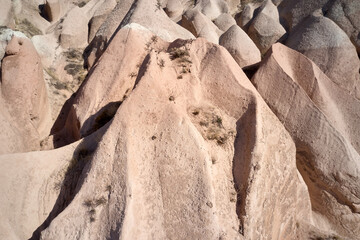 Unique geological formations in red valley, Cappadocia, Turkey. Rose valley stones close up.