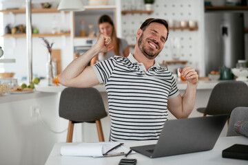 Young businessman having backache. Handsome man working at home.