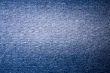 Texture of a light blue denim fabric with scuffs