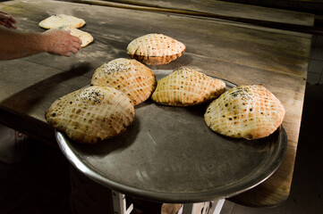 Traditional Bosnian Somun bread being prepared in a bakery