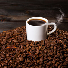 A cup of coffee on the background of coffee beans.