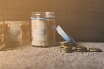 Money on table. Girl saving money. A lot of saved dollars.