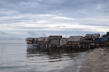 Over water stilt Bajau shanty houses built by indigenous people in the philippines. Long shot