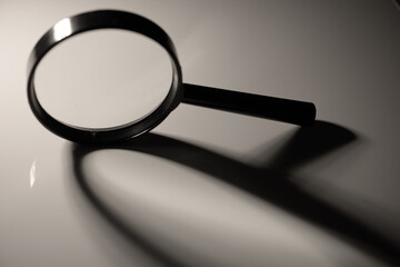 Fototapeta premium Magnifying glass with abstract shadow, black and white close up