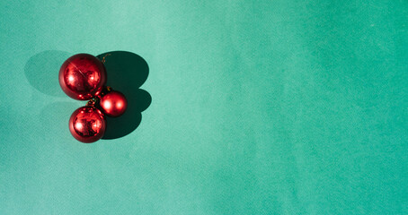 Christmas toys and decorations for the Christmas tree. Three red glossy shiny balls on a light...