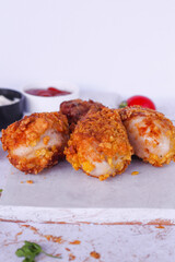 Delicious homemade crispy fried chicken with sauces on white marble background